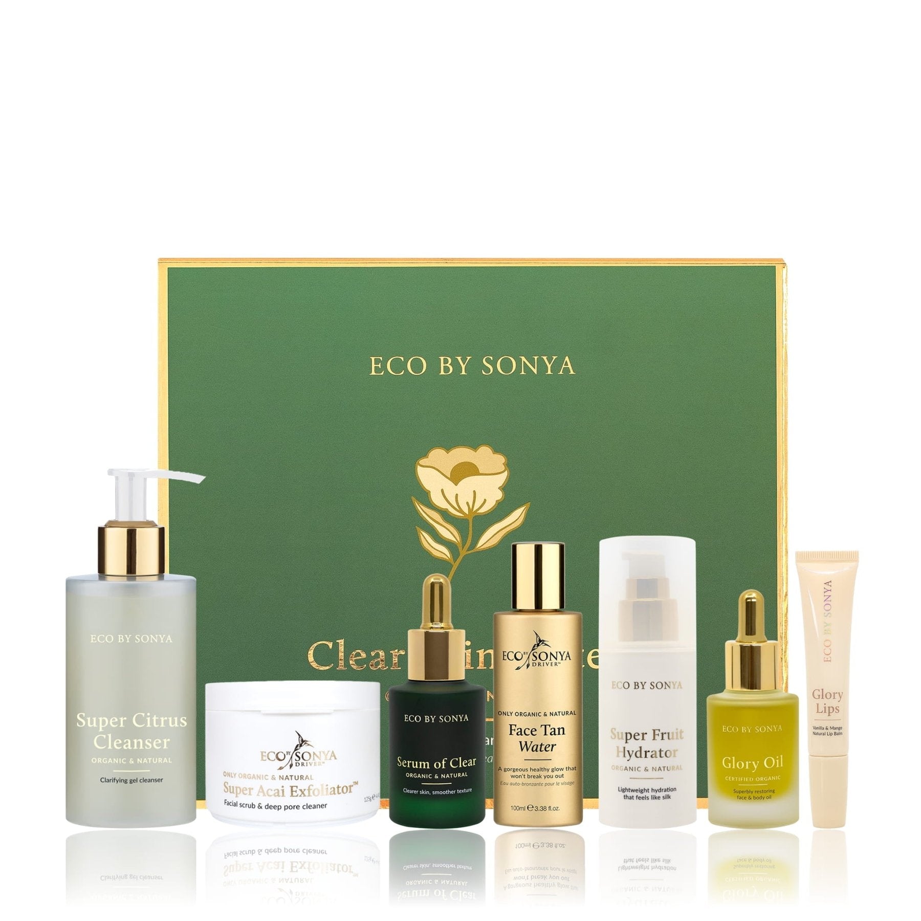 A collection of Eco By Sonya Clear Skin System products, including cleanser, serum, oil, Face Tan Water, hydrator, exfoliator and bonus lip balm, arranged together on a clean background.