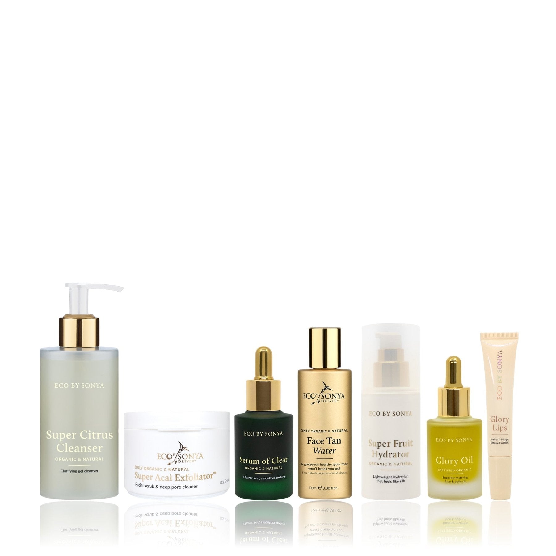 A collection of Eco By Sonya Clear Skin System products, including cleanser, serum, oil, Face Tan Water, hydrator, exfoliator and bonus lip balm, arranged together on a clean background.
