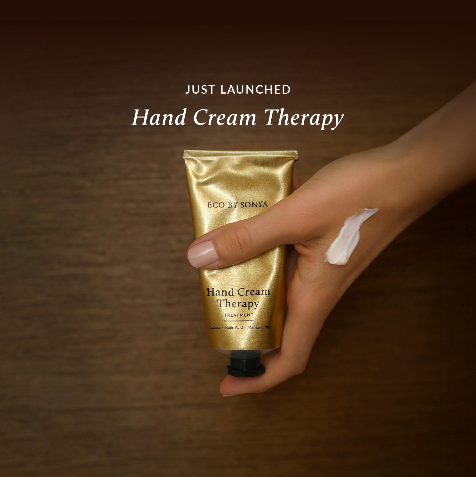 Hand holding Eco By Sonya Hand Cream Therapy Treatment with “Just Launched” text above.