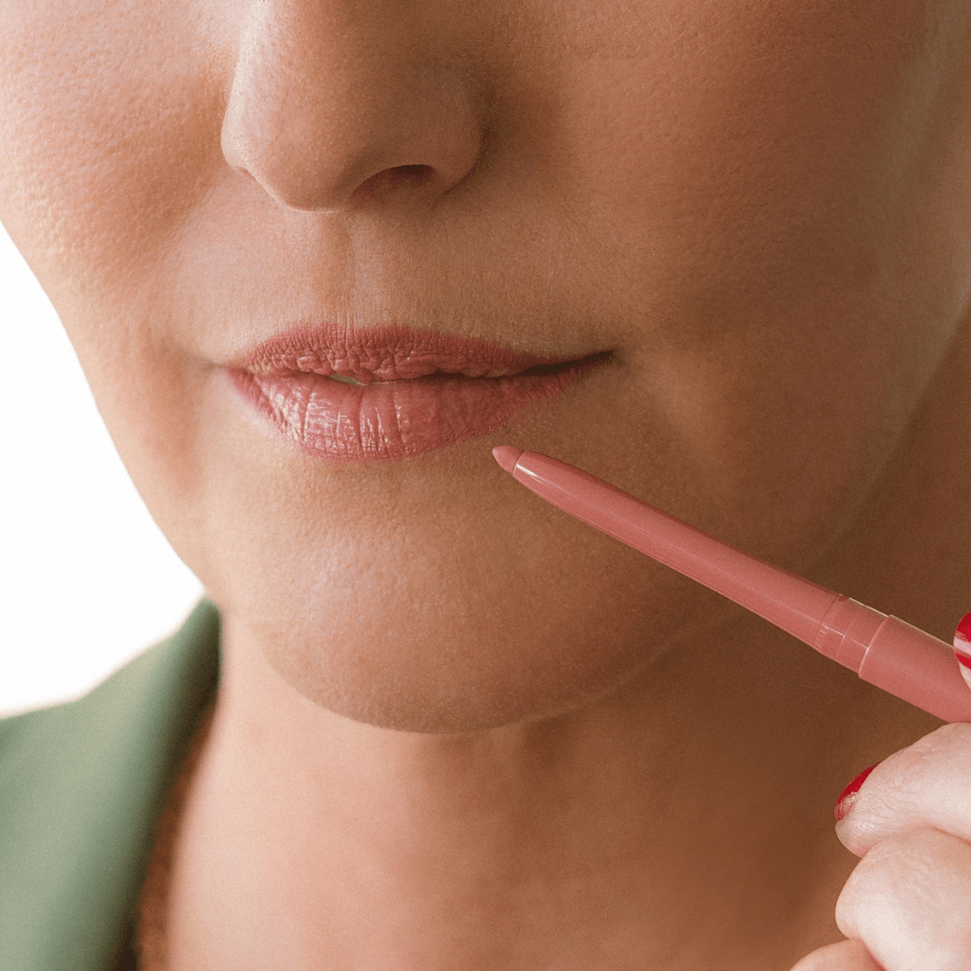Close-up of a woman applying Eco by Sonya perfect nude lip liner to lips