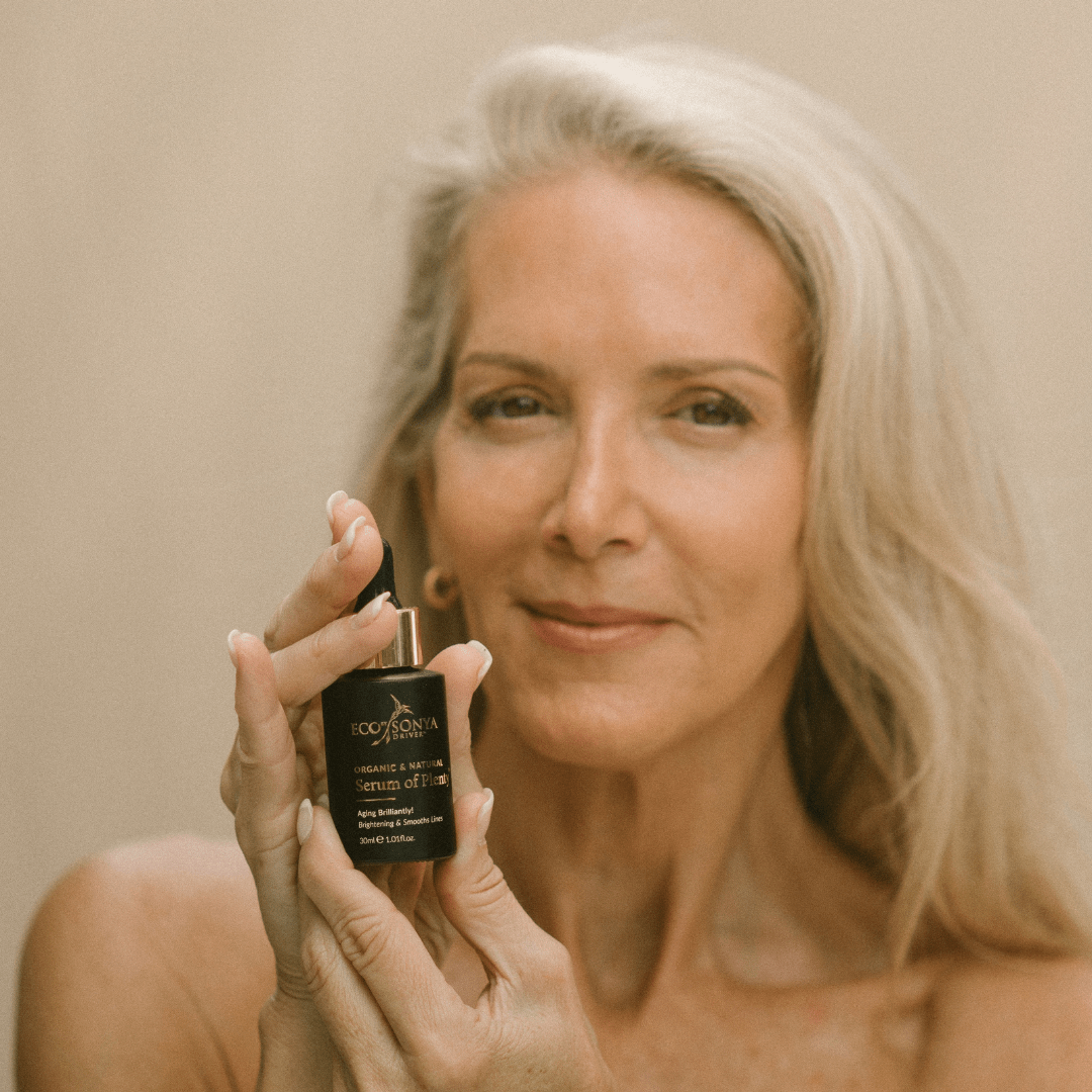 Woman holding Eco by Sonya natural vitamin C Serum of Plenty for mature skin
