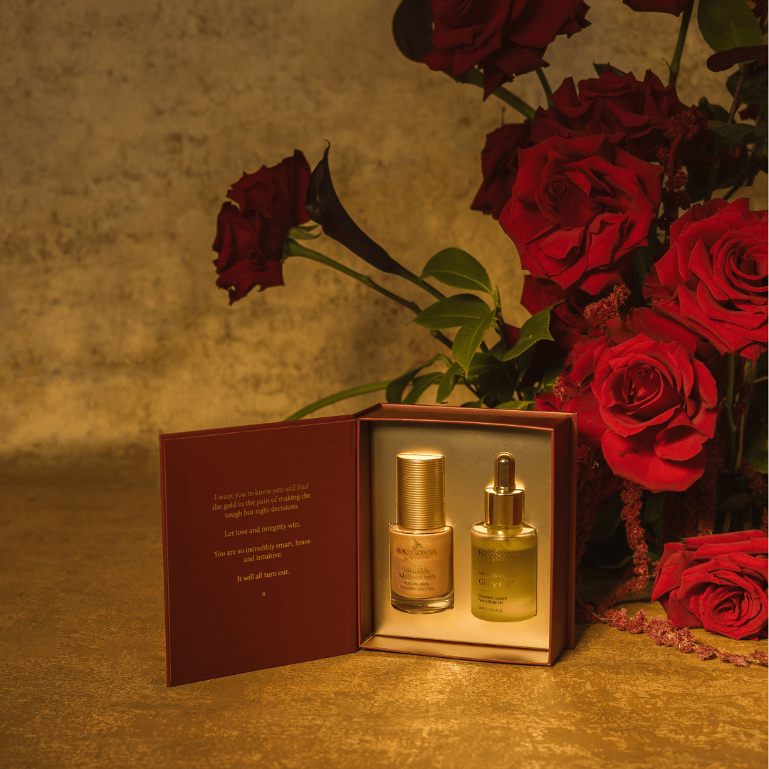 Eco by Sonya festive gift pack with Glory Oil and Golden Illuminiser on gold background with Roses 