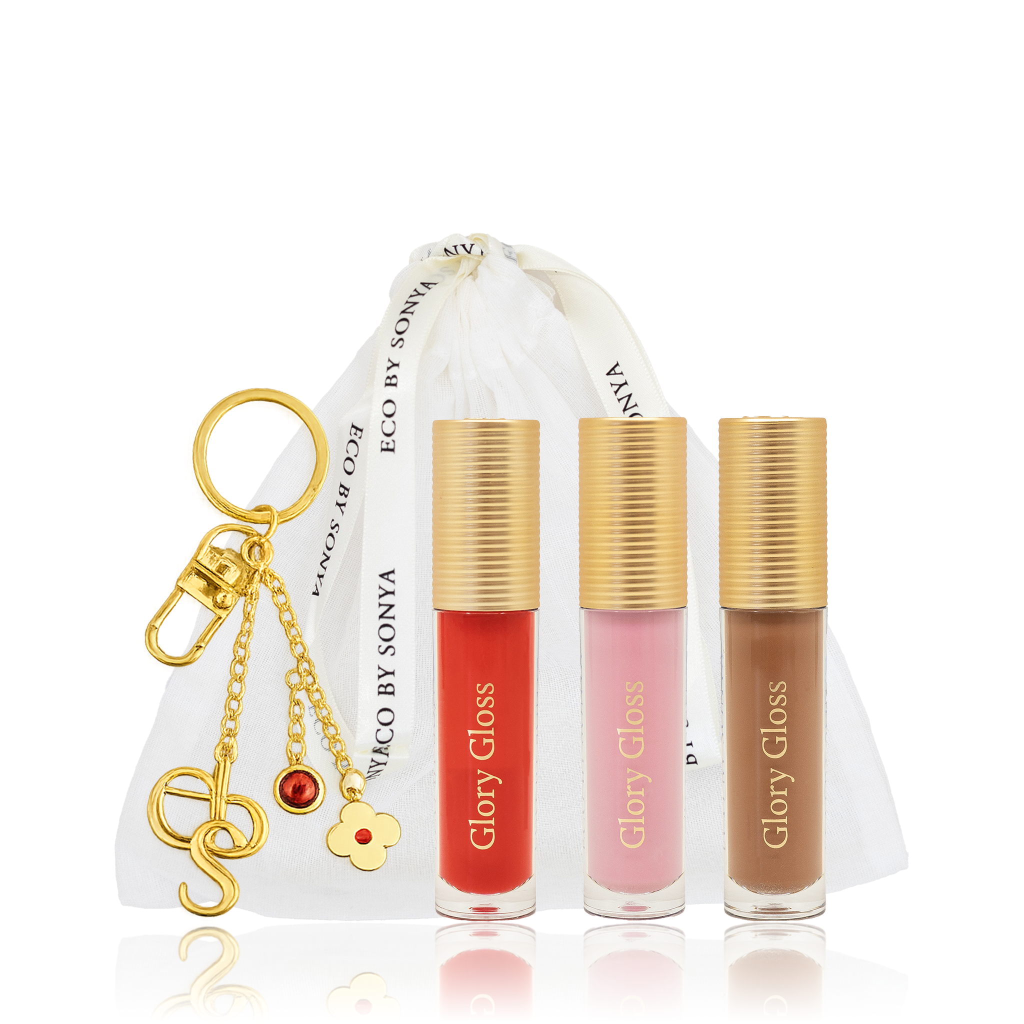 Three Glory Gloss shades with gold caps and a gold charm keyring on a white background.